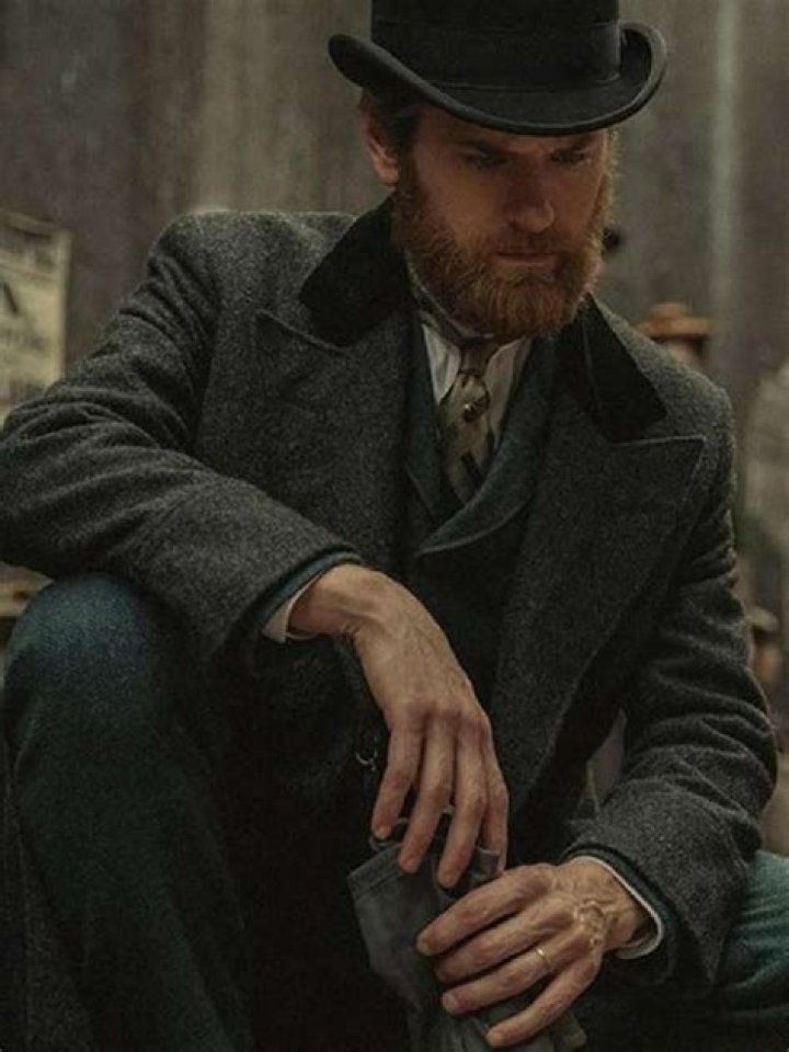 Kyle Soller in black coat with Phoenix Fox on white dress.